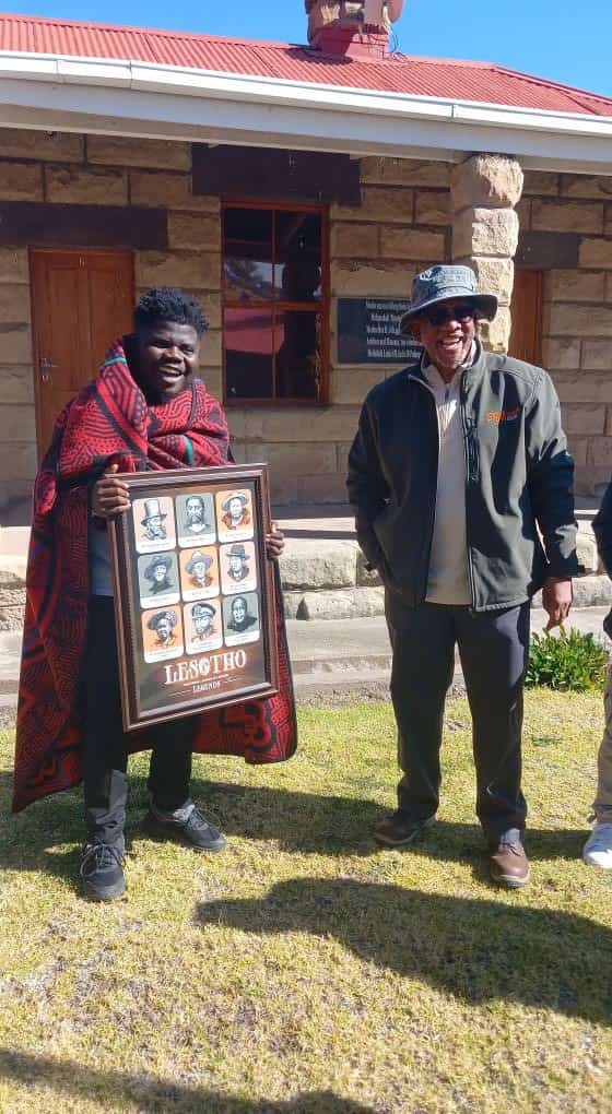 Wademaya and the Principal Chief holding a framed Lesotho Legends artwork
